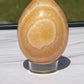 Orange calcite crystal egg carving