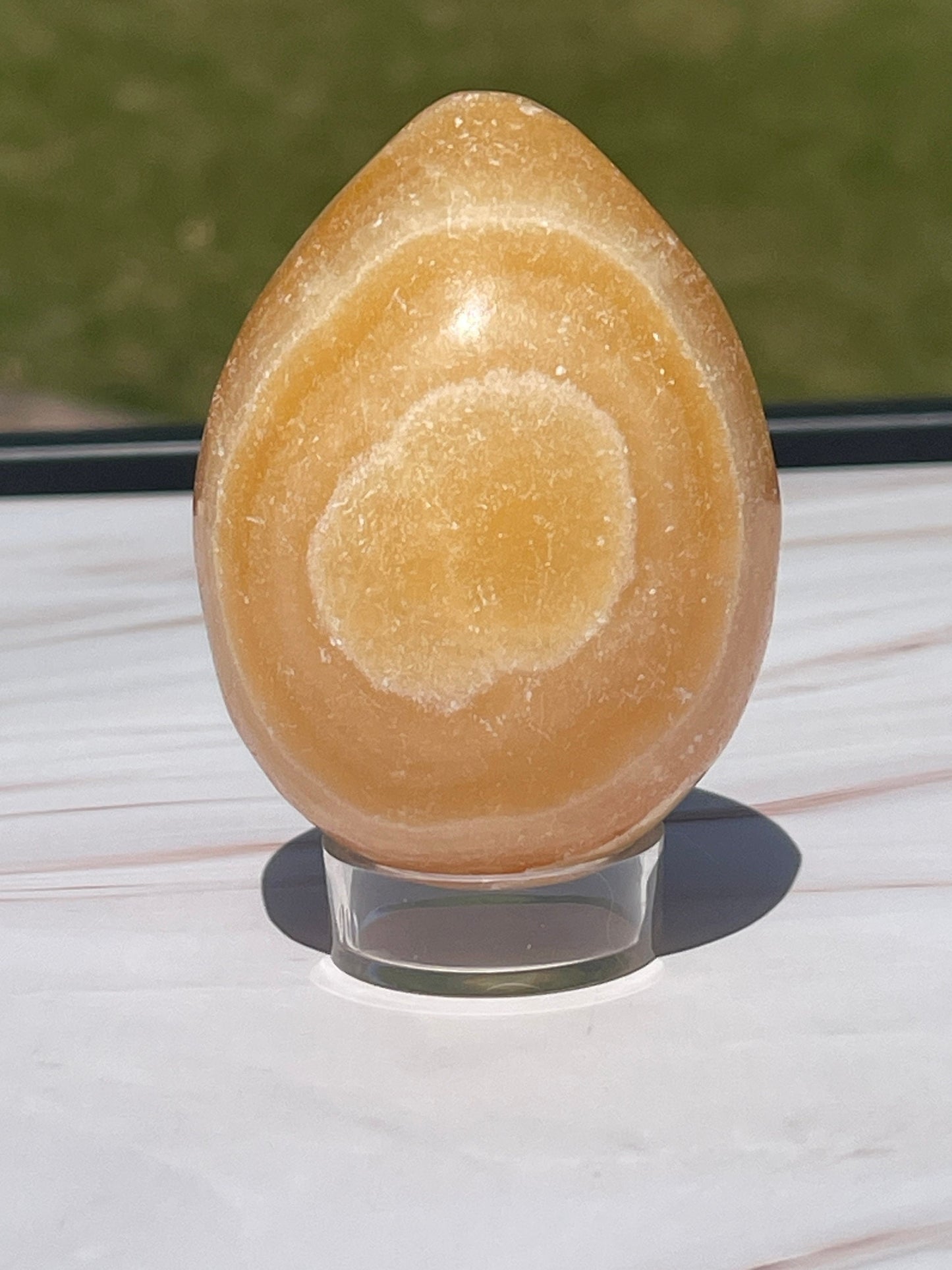 Orange calcite crystal egg carving