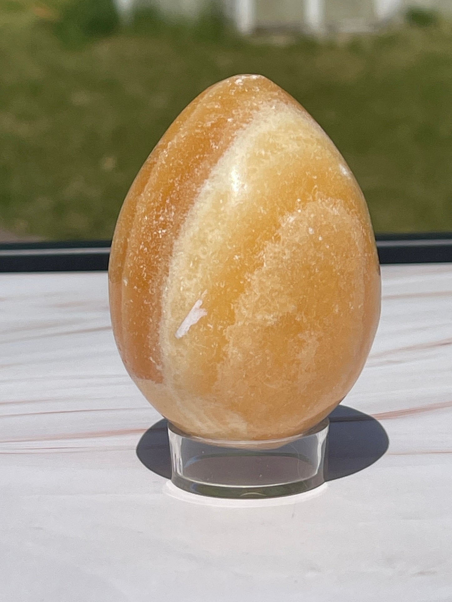 Orange calcite crystal egg carving