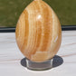 Orange calcite crystal egg carving