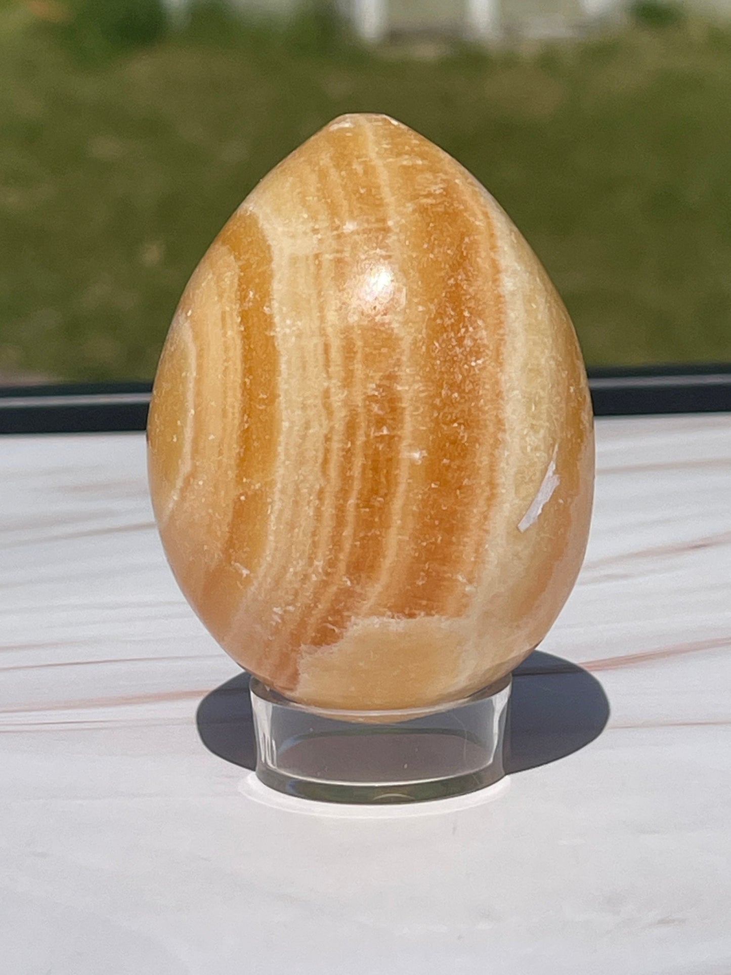 Orange calcite crystal egg carving