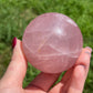 Rose quartz sphere with rainbow