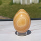 Orange calcite crystal egg carving