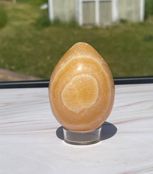 Orange calcite crystal egg carving