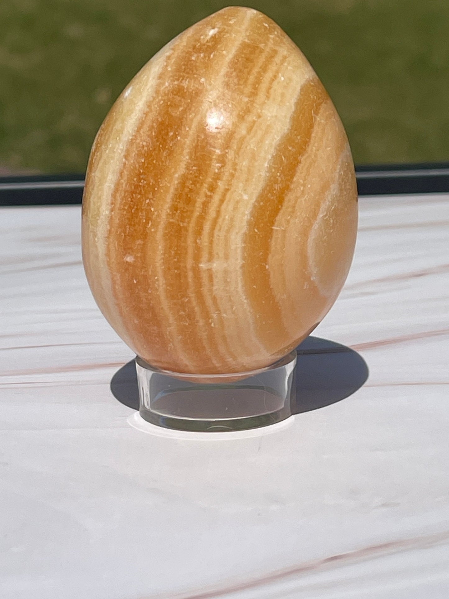Orange calcite crystal egg carving